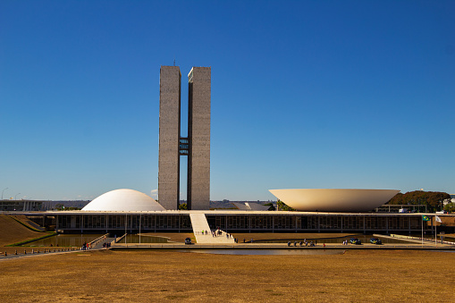Brasília, Federal District, Brazil – July 23, 2022: Cityscape - National Congress in Brasilia  with blue sky in the background. Federal Capital of Brazil. It is an architectural work by Oscar Niemeyer.