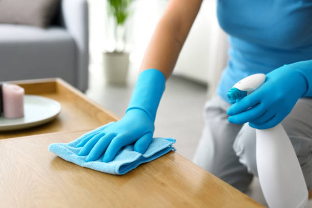 istock Woman cleaning a table at home 1410839599