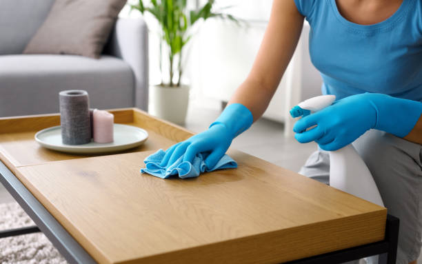 istock Woman cleaning a table at home 1410839696