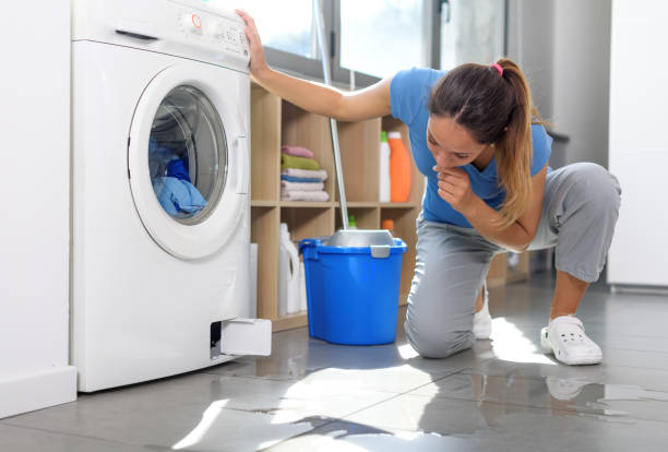 istock Woman checking a water leak on the floor 1410840587