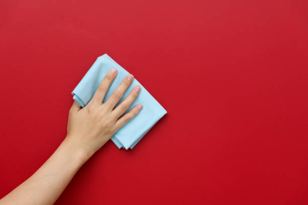 istock Woman hand cleaning red wall with rag 1410843272