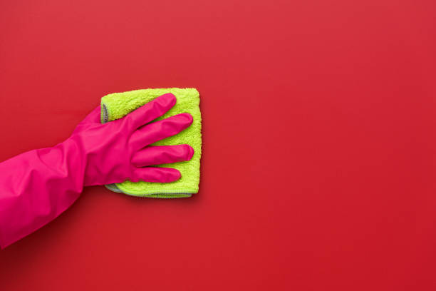 istock Woman hand cleaning red wall with rag 1410843298