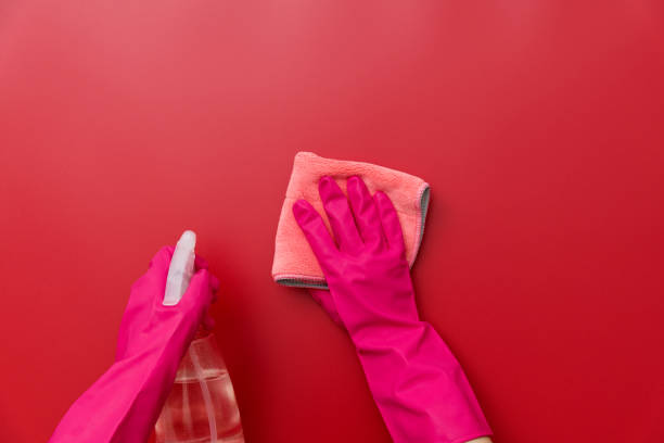 istock Woman hand cleaning red wall with rag 1410843379