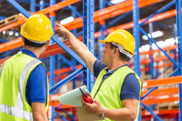 istock Workers team taking inventory in factory warehouse, Foreman workers working in warehouse talking about job 1410843399
