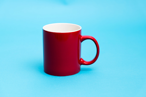 Red mug on blue background.