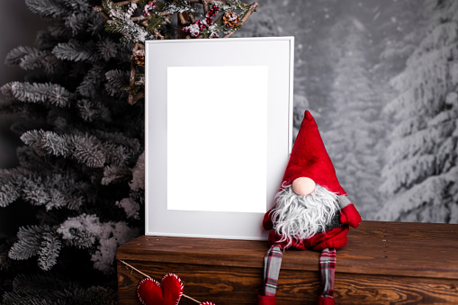 White picture frame with decorations. Mock up for your photo or text. Place your work, print art, white background, pastel color book. Photo realistic 3d illustration. Minimalist Christmas interior decoration