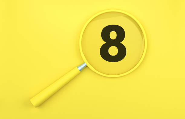 Yellow magnifying glass over number 8 on yellow background.