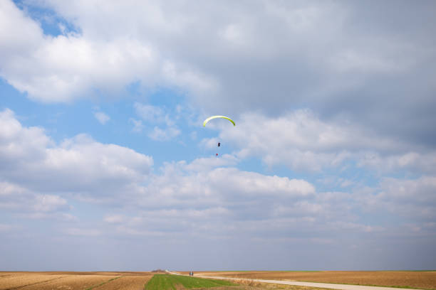 Paragliding in sky. Paraglider tandem flying over sea and mountains in cloudy day. view of paraglider and Blue Lagoon in Oludeniz, Turkey. Extreme sport. Landscape