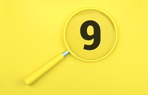 Yellow magnifying glass over number 9 on yellow background.