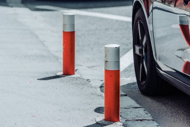 istock Car parked next to road poles 1410847024