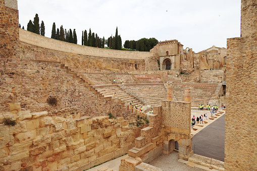 15th June, 2022. Tourists visiting an ancient amphitheatre in Cartagena, Spain.