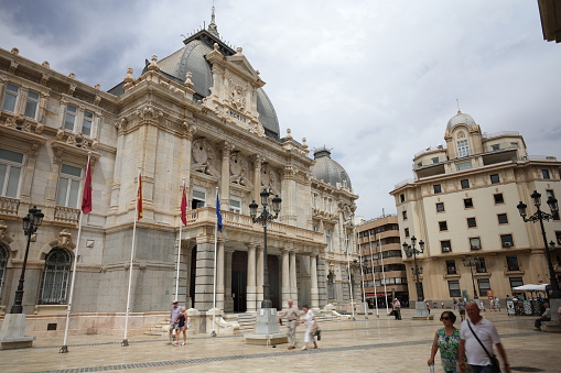 15th June, 2022. Tourists and locals walking around the town hall and plaza  in the historical town of Cartagena in Spain
