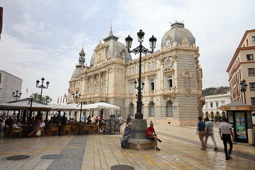 15th June, 2022. Tourists and locals walking around the town hall and plaza  in the historical town of Cartagena in Spain