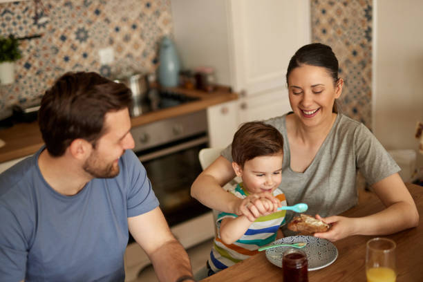istock Parents spending some quality time with their adorable son at breakfast time 1410850336