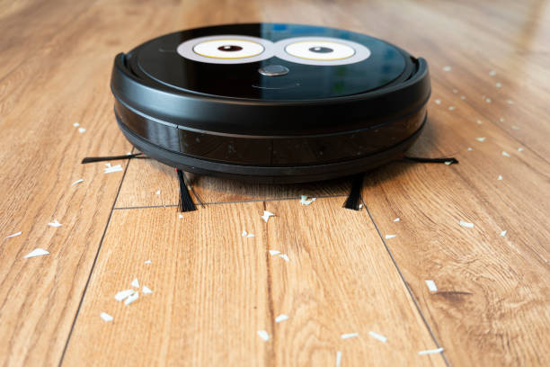 istock Robotic vacuum cleaner on wood floor smart cleaning technology. 1410854038