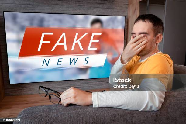 Lies Of Tv Propaganda Mainstream Media Disinformation A Fake News Report Viewer Is Watching Tv And Doesnt Believe In Fake News Man Closes His Eyes Not To Watch The Lies On Tv Stock Photo - Download Image Now