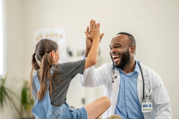 istock Doctor Giving a Young Female Patient a High Five 1410859611