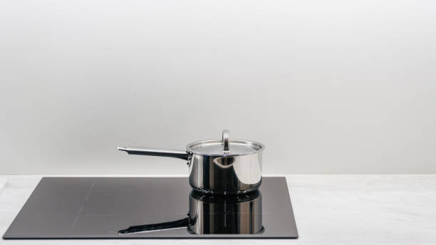 istock Saucepan on a glass-ceramic induction stove hob 1410861423