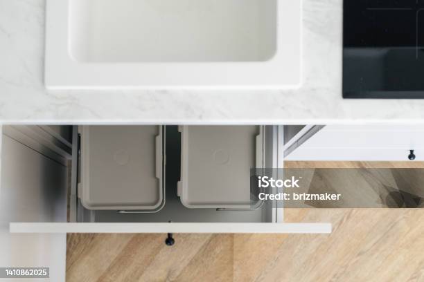 Recycling Boxes Over Sink In White Modern Kitchen Stock Photo - Download Image Now - Kitchen, Garbage Can, Garbage Bin