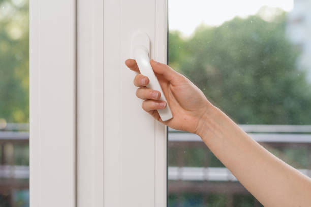 istock Woman hand open plastic window in living room 1410862230