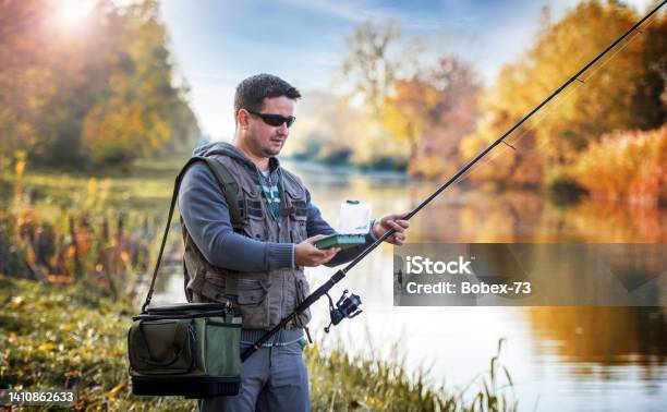 Angler Choosing Bait While Trying To Catch A Trophy Fish On The River Sport And Recreation Concept Stock Photo - Download Image Now
