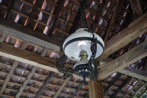 Antique decorative lamps hanging from the ceiling of the room have ethnic nuances.