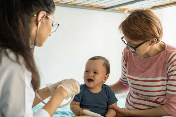istock Doctor inspecting a toddle at his home 1410865083