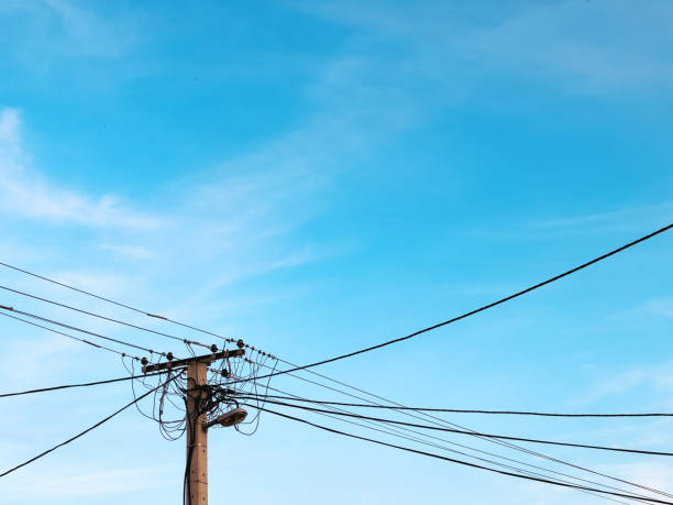 istock Old concrete electricity pole with power line cables 1410865588