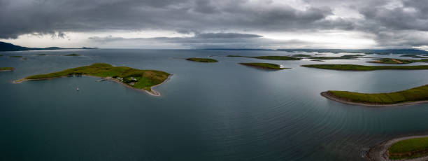 panorama landscape of the sunken drumlin islands of Clew Bay in County Mayo of western Ireland panorama landscape of the sunken drumlin islands of Clew Bay in County Mayo of western Ireland under an overcast sky clew bay stock pictures, royalty-free photos & images