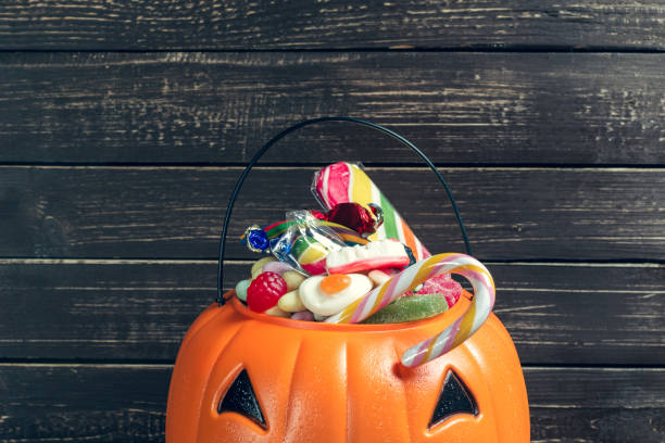 istock Happy halloween! Pumpkin with candy in the home. 1410867998