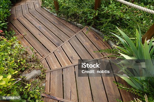 istock Staircase and wooden terrace Garden of the house  Abundant and verdant vegetation 1410868147