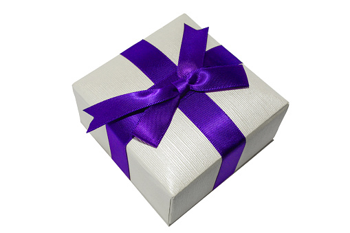 Small gift box with blue ribbon isolated on white background. Jewelry/holiday box close up