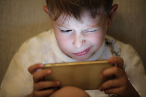 Myopia Symptoms, Child Plays Video Game With Phone