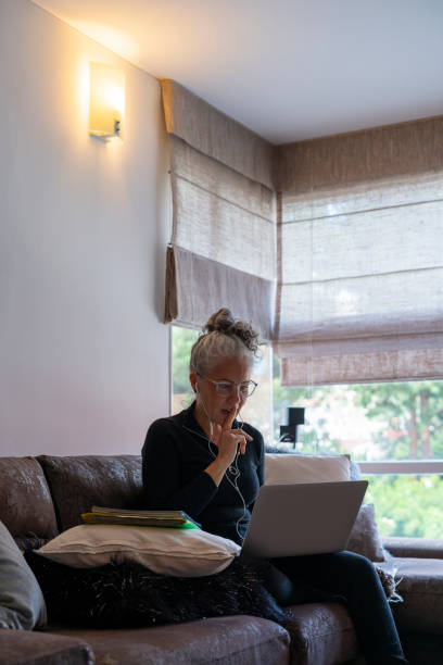 istock beautiful older woman receives classes in virtual mode 1410871209