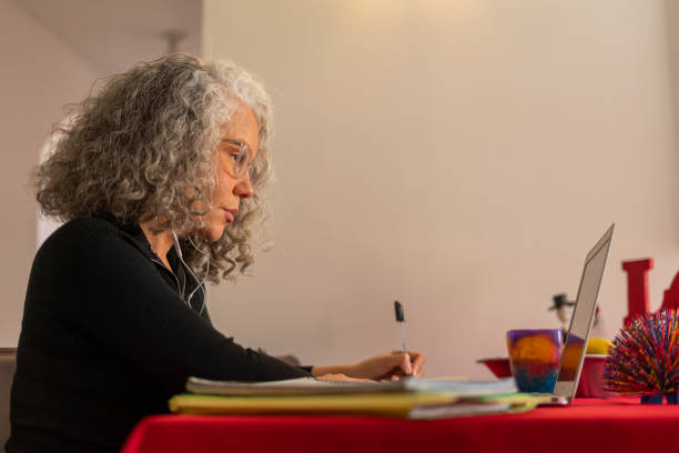 istock beautiful older woman receives classes in virtual mode 1410871223