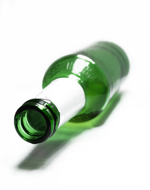 istock Closeup of opened green bottle. Beer bootle isolated on white background 1410873253