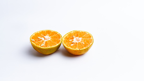 Close-up of freshly cut orange fruit isolated on white background