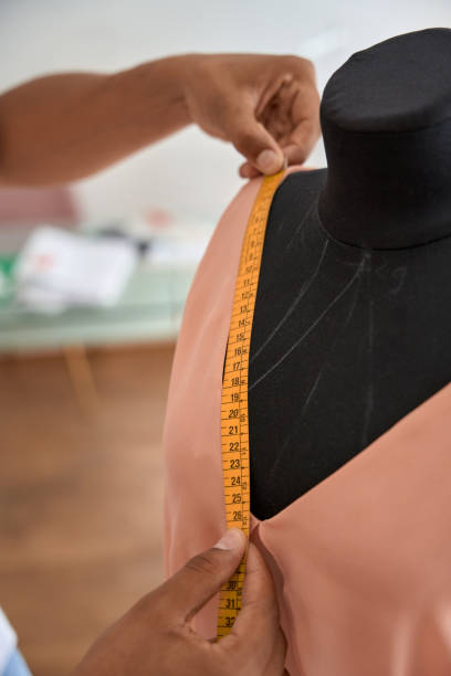 istock Male tailor doing measurements for new dress 1410875222