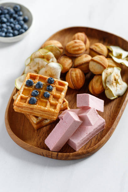 wooden dish with sweets, waffles and pastilles. natural sweets. apple chips. - pastilles imagens e fotografias de stock