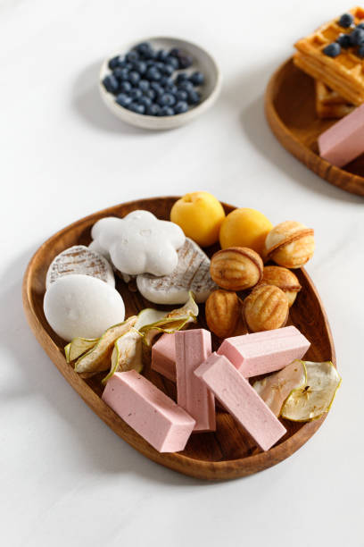 wooden dish, plate with sweets, gingerbreads, waffles and pastilles. natural sweets. apple chips. - pastilles imagens e fotografias de stock