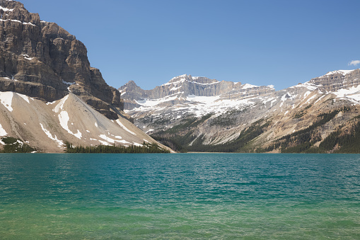 Summer day with emerald blue water and mountain glacier landscape of Bow Lake in Banff National Park, Alberta, Canada.