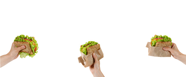 Banner with Sandwiches, snacks. Toasts with fresh lettuce, tomatoes and sausage in woman hands. Eating Healthy snack, take away food. Copy space, text.