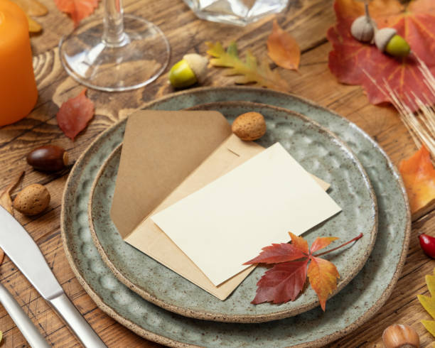 istock Autumn table setting with place card and envelope between leaves and berries close up, mockup 1410877648
