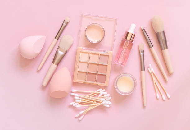 istock Natural beige eye shadow and decorative cosmetics on light pink, top view 1410877703