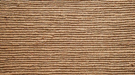Texture of the woven jute carpet. Natural organic fiber