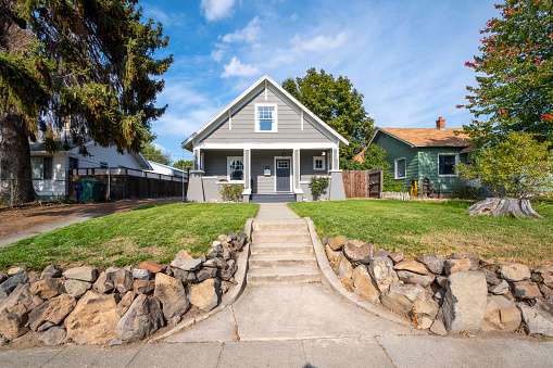 A historic Victorian home in downtown Spokane, Washington, with a walkway to a covered porch.