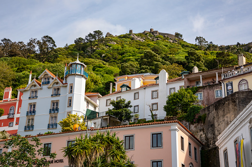 View over the houses of Sintra up to the castle fortress of Castelo dos Mouros in the forest above the town, Portugal