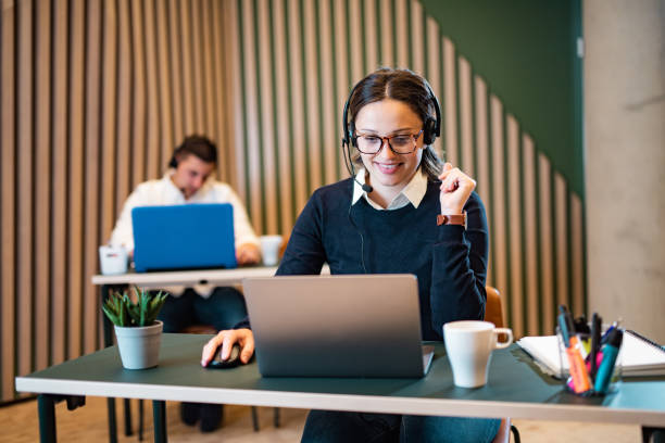 istock Female customer service representative working on laptop in a call center 1410881821