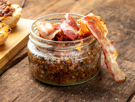 jar with bacon jam close-up wooden table.jar with bacon jam close-up wooden table.