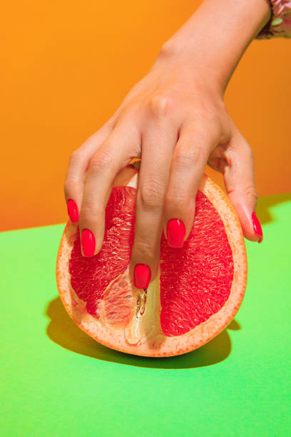 istock Image of juicy grapefruit isolated on green orange background 1410882647